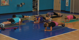picture of ladies doing low impact aerobics inside a gym